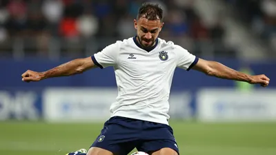 A tight action crop of an anonymous Annecy player, aged 25-30, with a rugged build, in a floodlit stadium, wearing a...